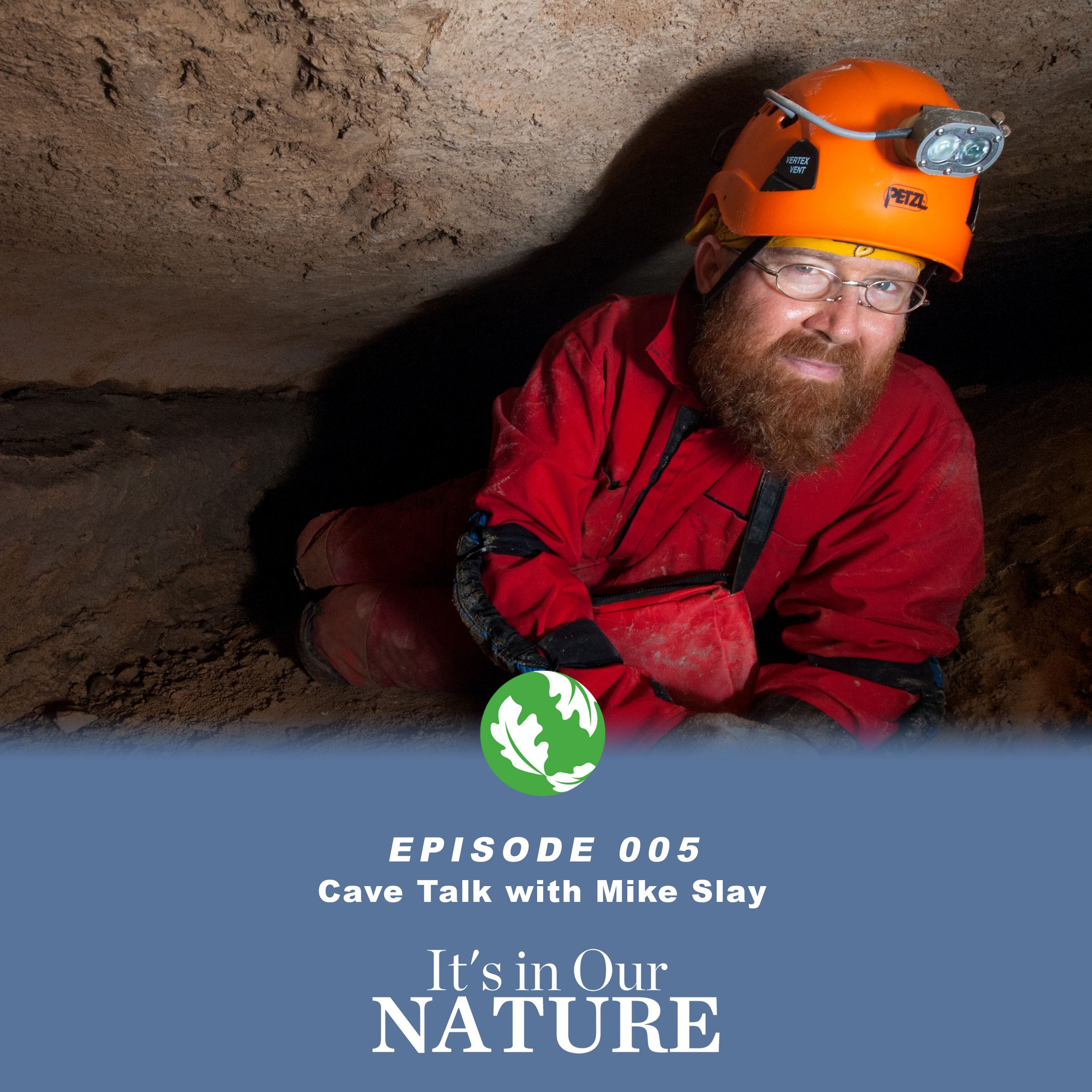 A man wearing a lighted helmet in a cave smiling for the picture. 