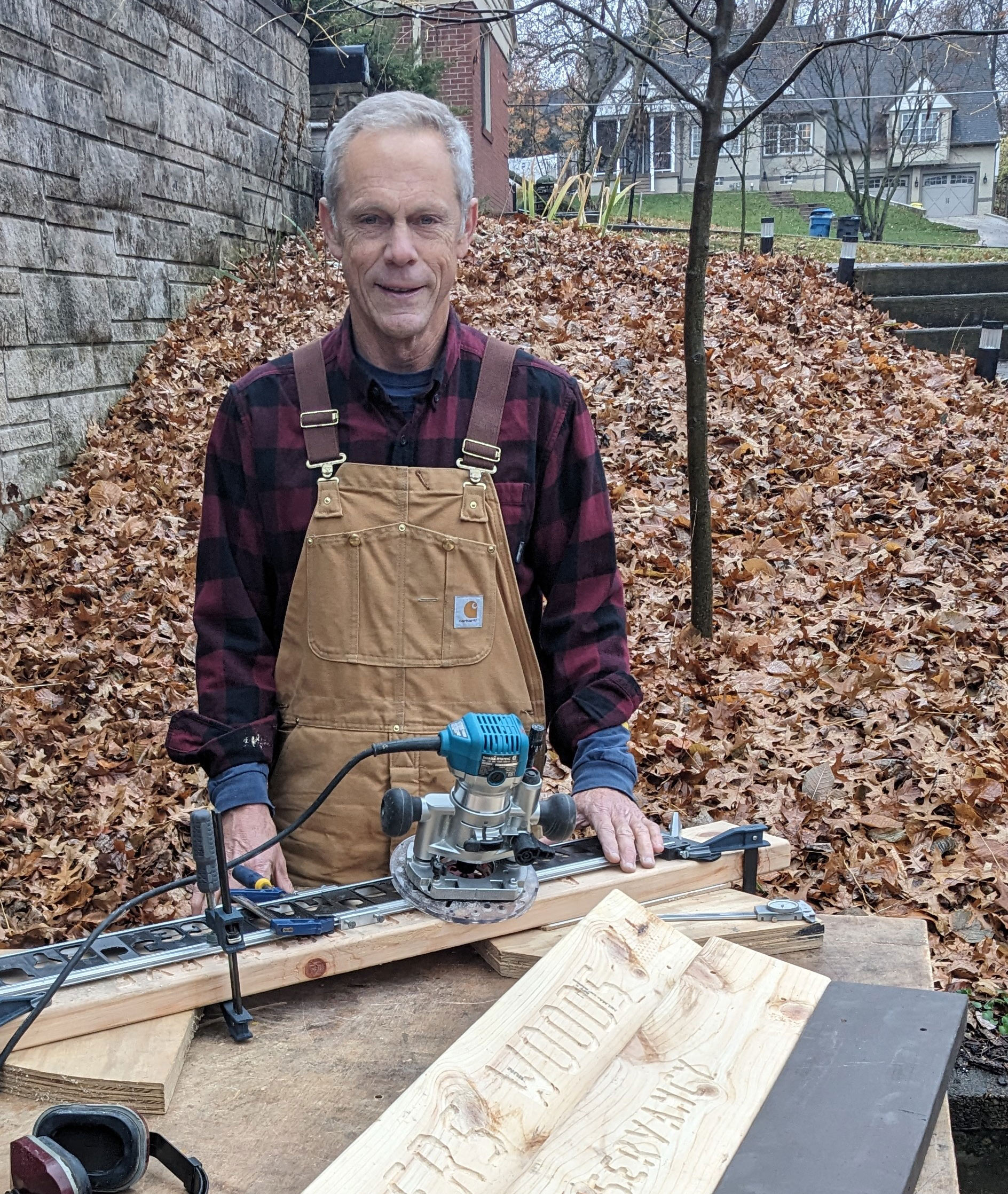 TNC volunteer Bill Cummings creating a wooden routed sign for a preserve.