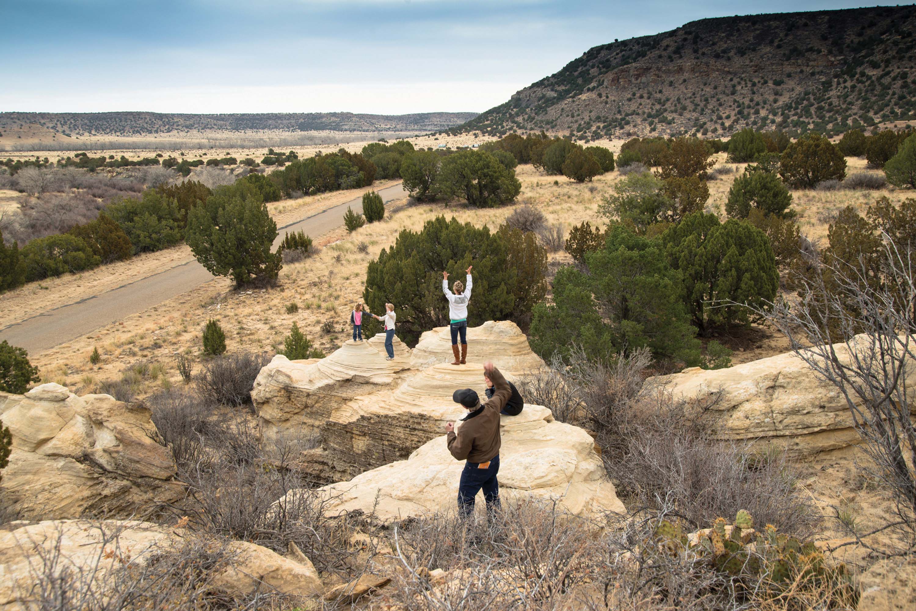 hikers climbing on boulders