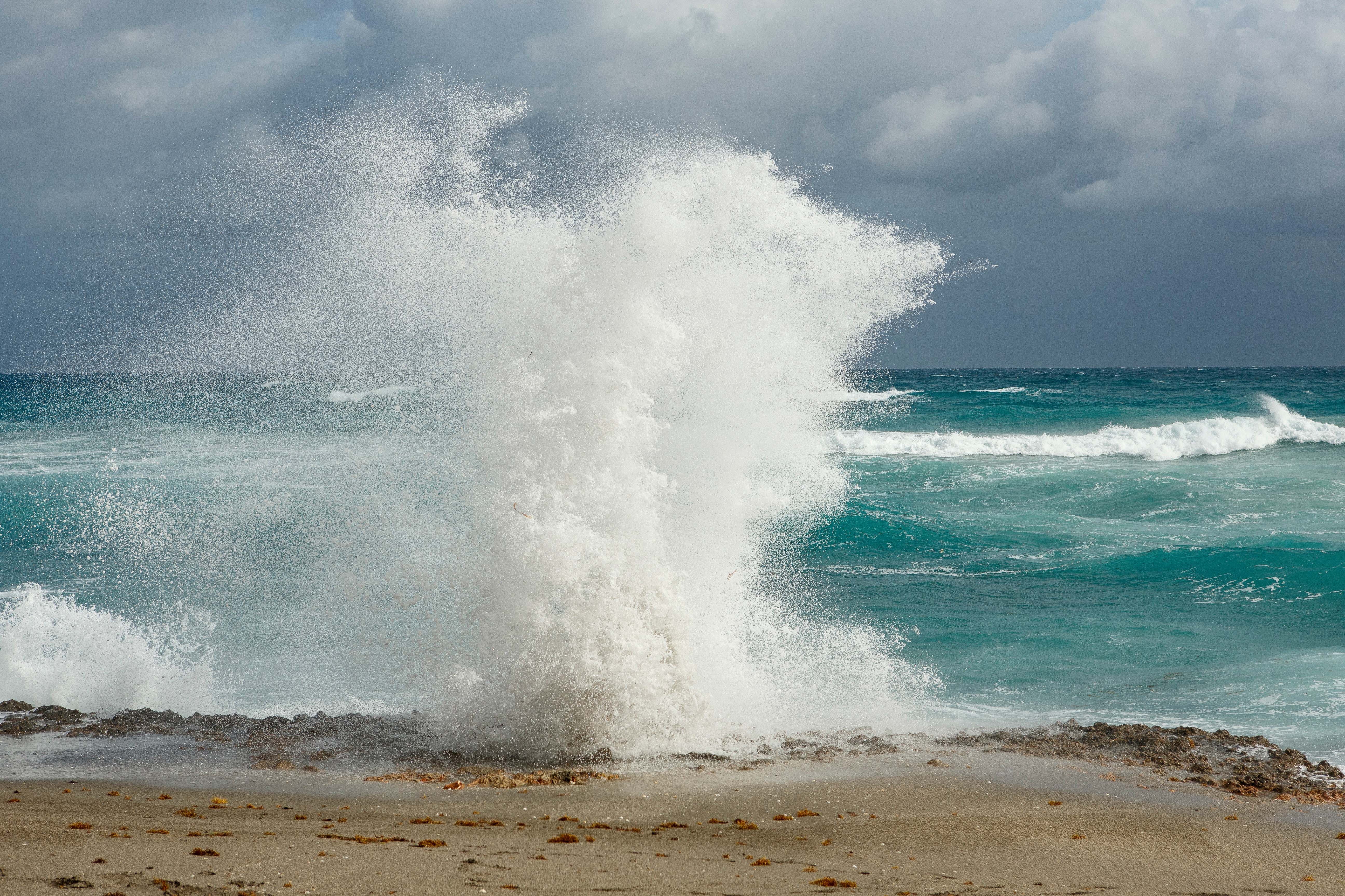 Blowing Rocks Preserve beach. Water is shooting up through the rocks.