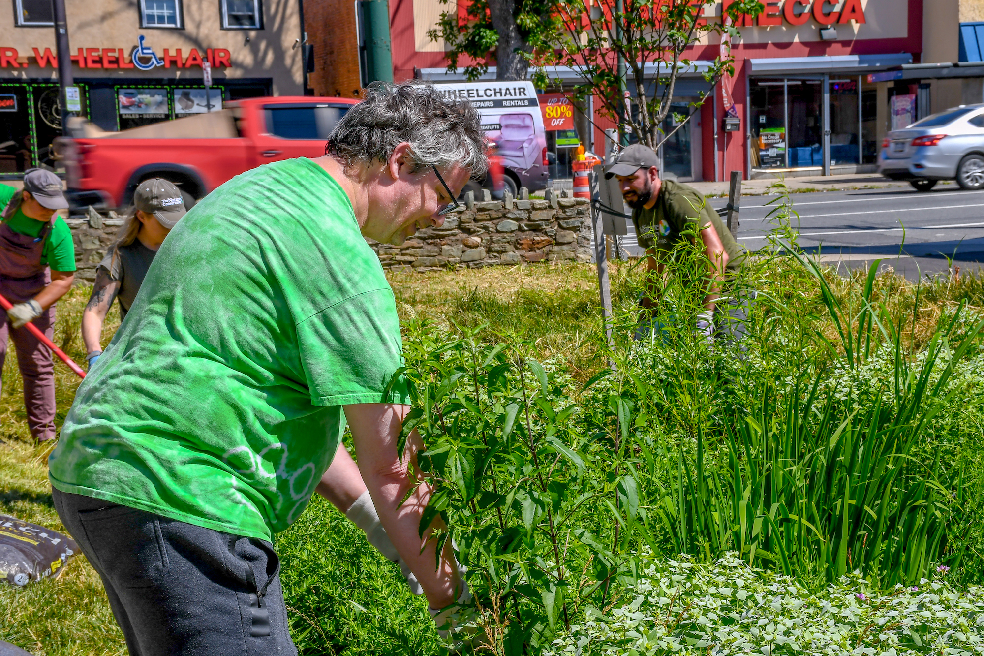 Staff and community members perform maintenance. 