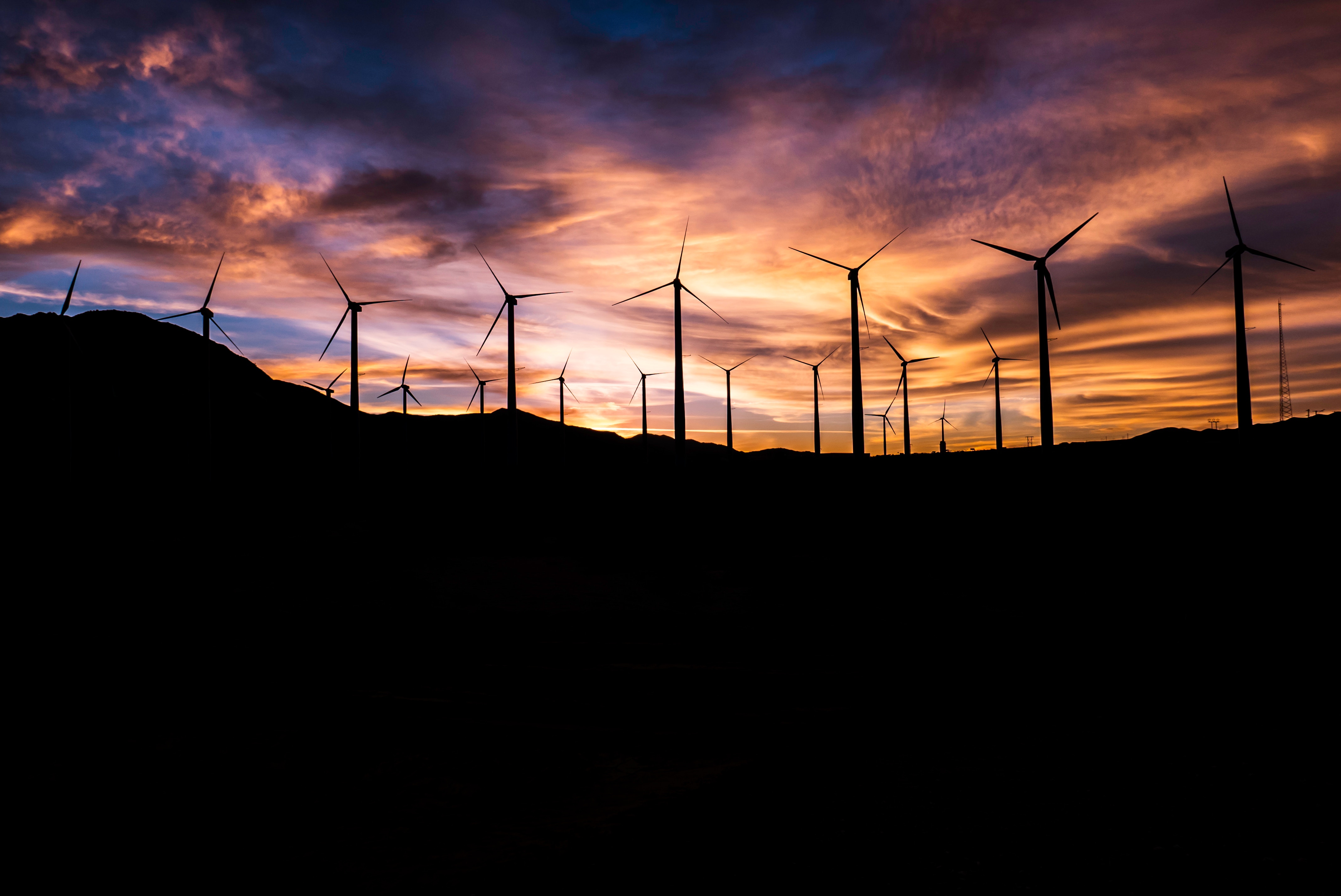 Photo of wind turbines at sunset.