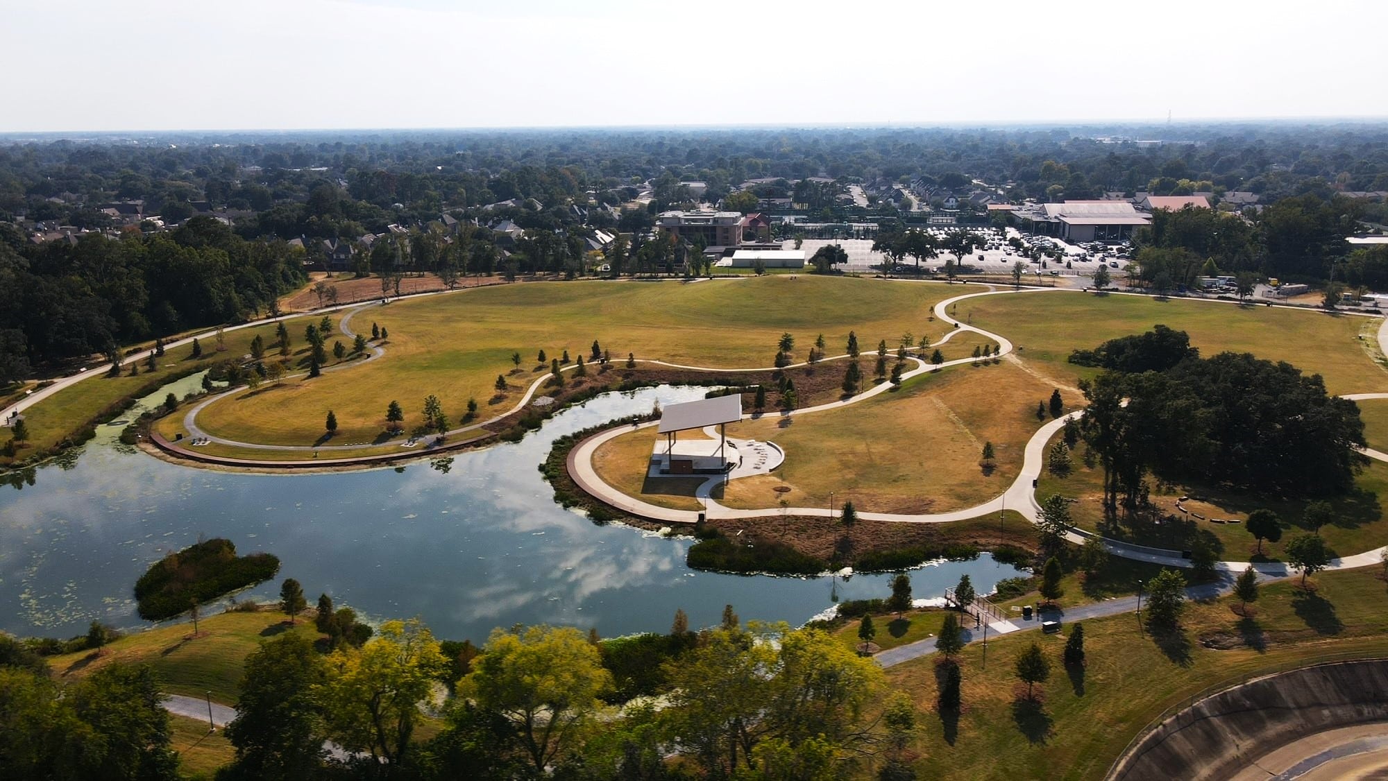 A small lake surrounds a park.