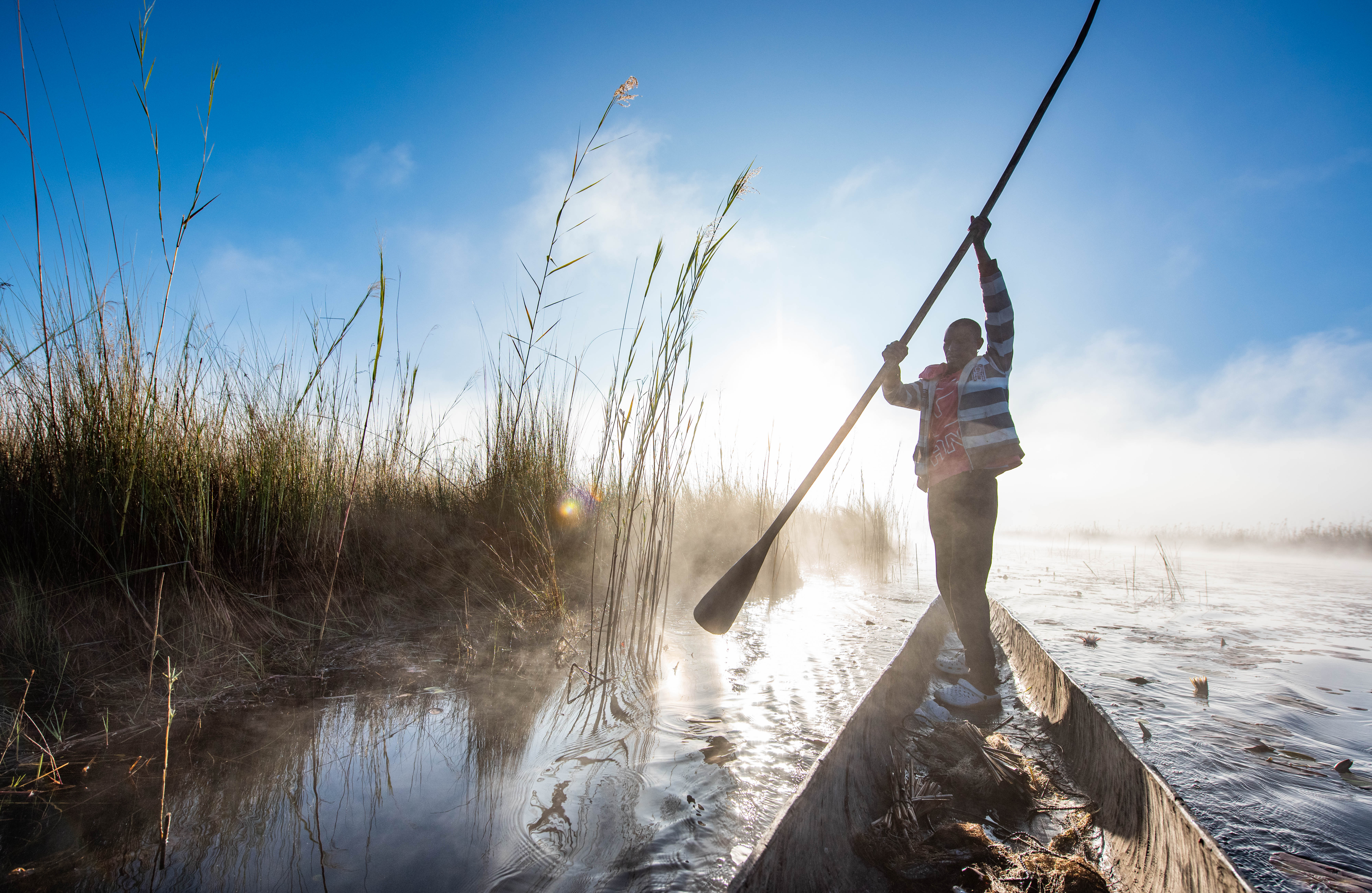 Fisherman checking his  nets in a lagoon.