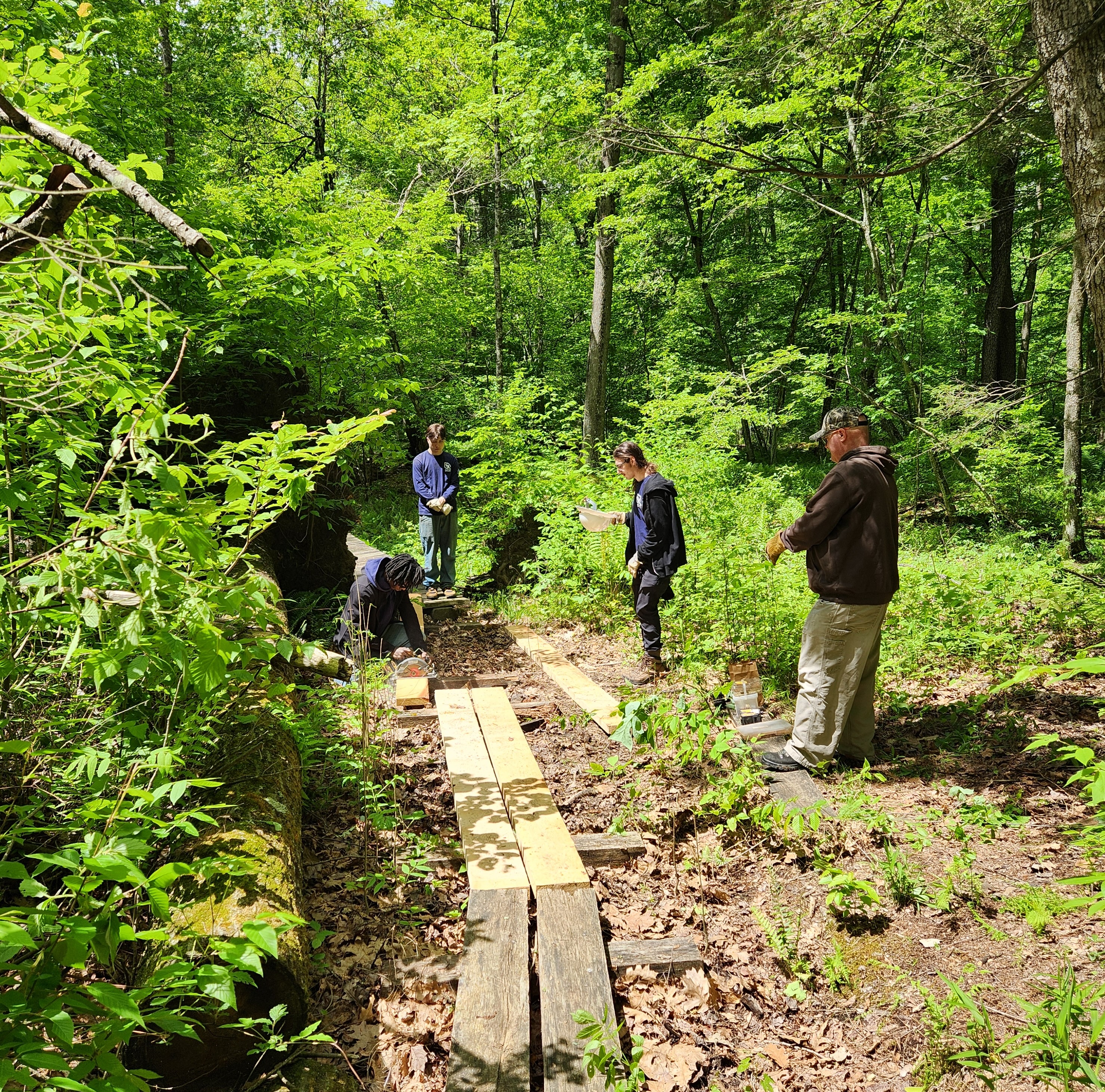 four volunteers working in the drury preserve.
