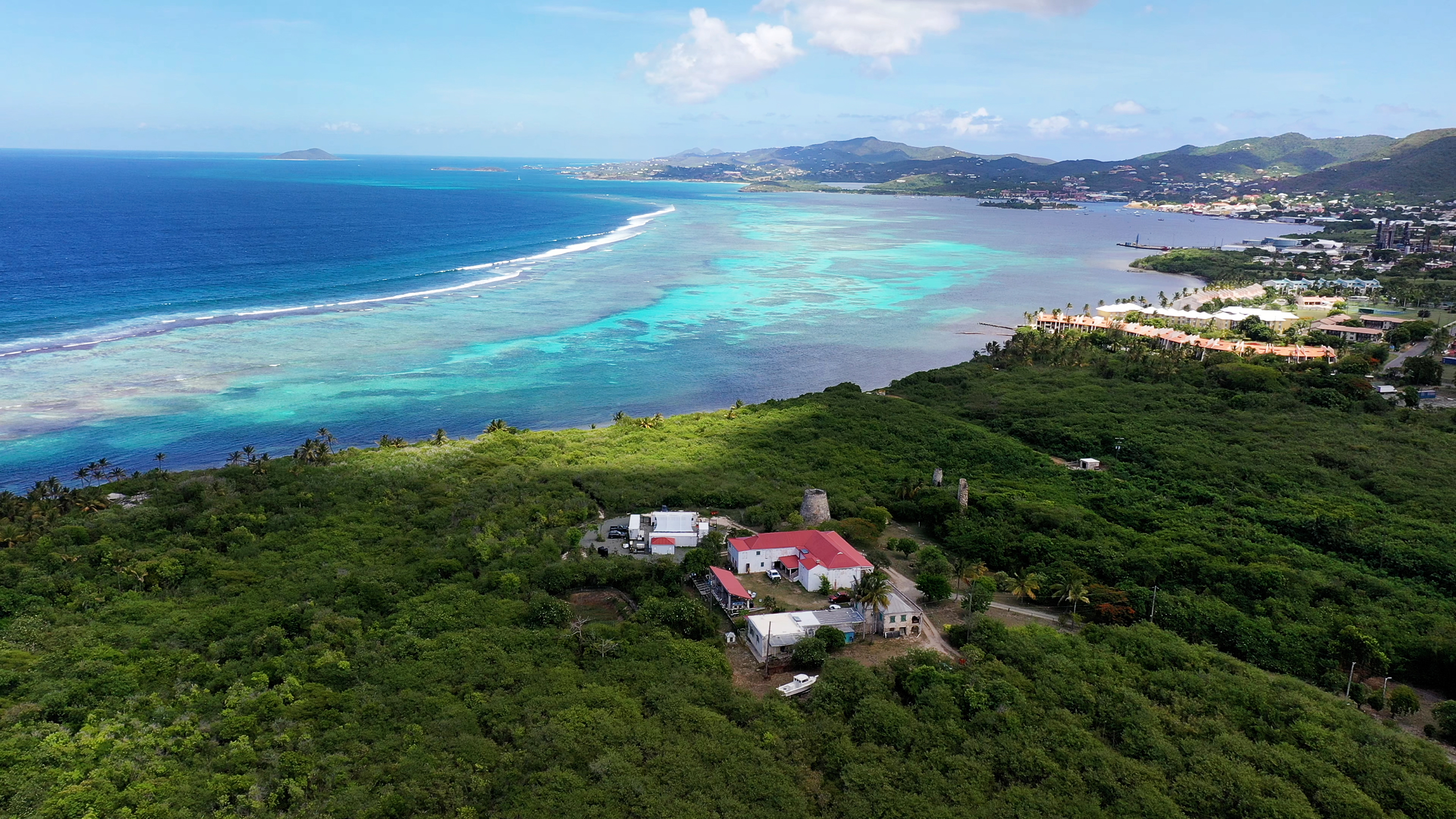 Aerial view of TNC's Coral Innovation Hub on St. Croix, U.S. Virgin Islands, surrounded by green vegetation with blue ocean on the horizon